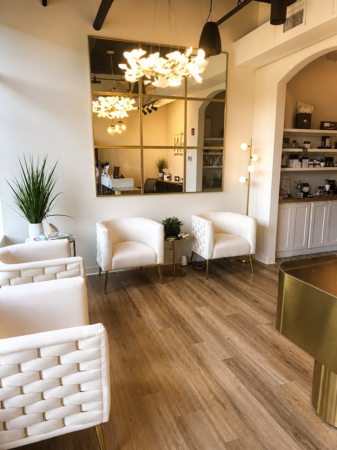 The Skin LAB’s light-filled lobby, with white chairs and gold accents